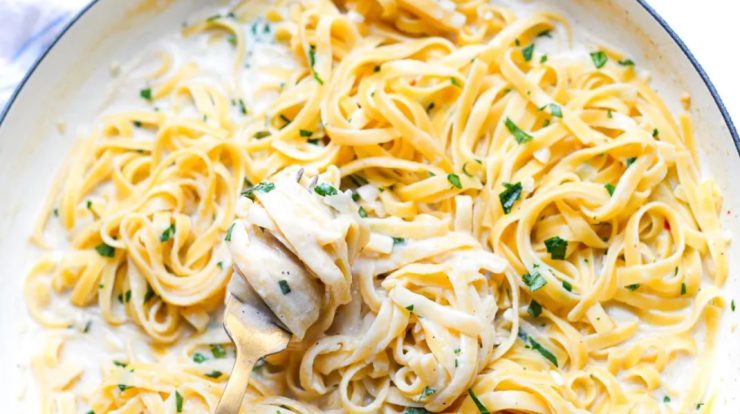A bowl of creamy one-pot garlic parmesan pasta garnished with fresh parsley