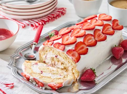 A sliced Strawberry Tiramisu Roll showcasing layers of ladyfingers and strawberry cream.